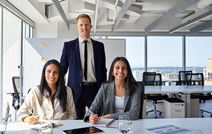 Happy professional diverse team business people in office meeting room. International company workers group, multiethnic smiling employees coworkers staff posing for team portrait.